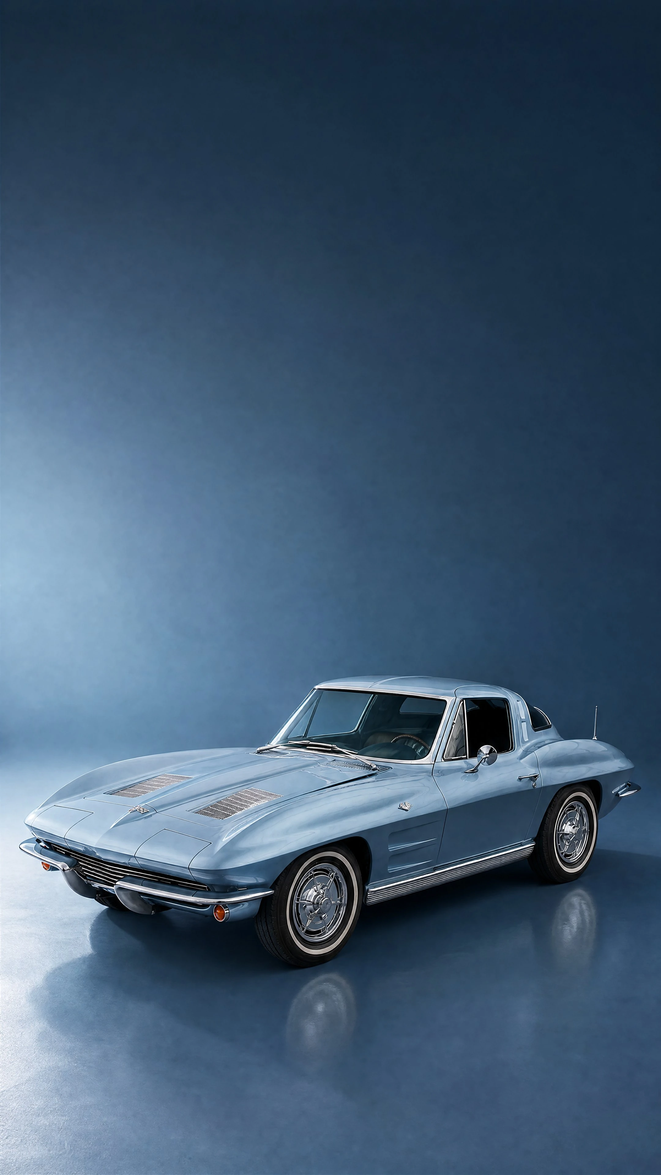 A Silver Blue 1963 Corvette Sting Ray split-window coupé, front three-quarter view on a deep steel-blue field in cool daylight
