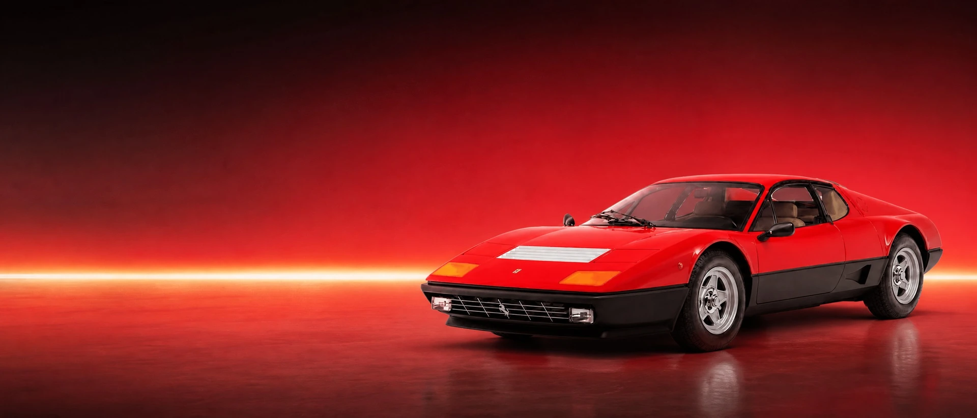 A red Ferrari Berlinetta Boxer, front three-quarter view on a field with a wide warm light band