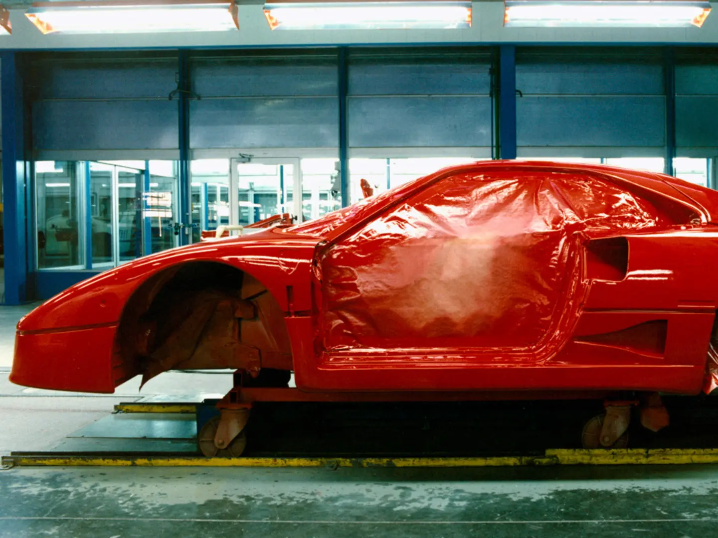 A bare F40 composite body shell on the line at Maranello