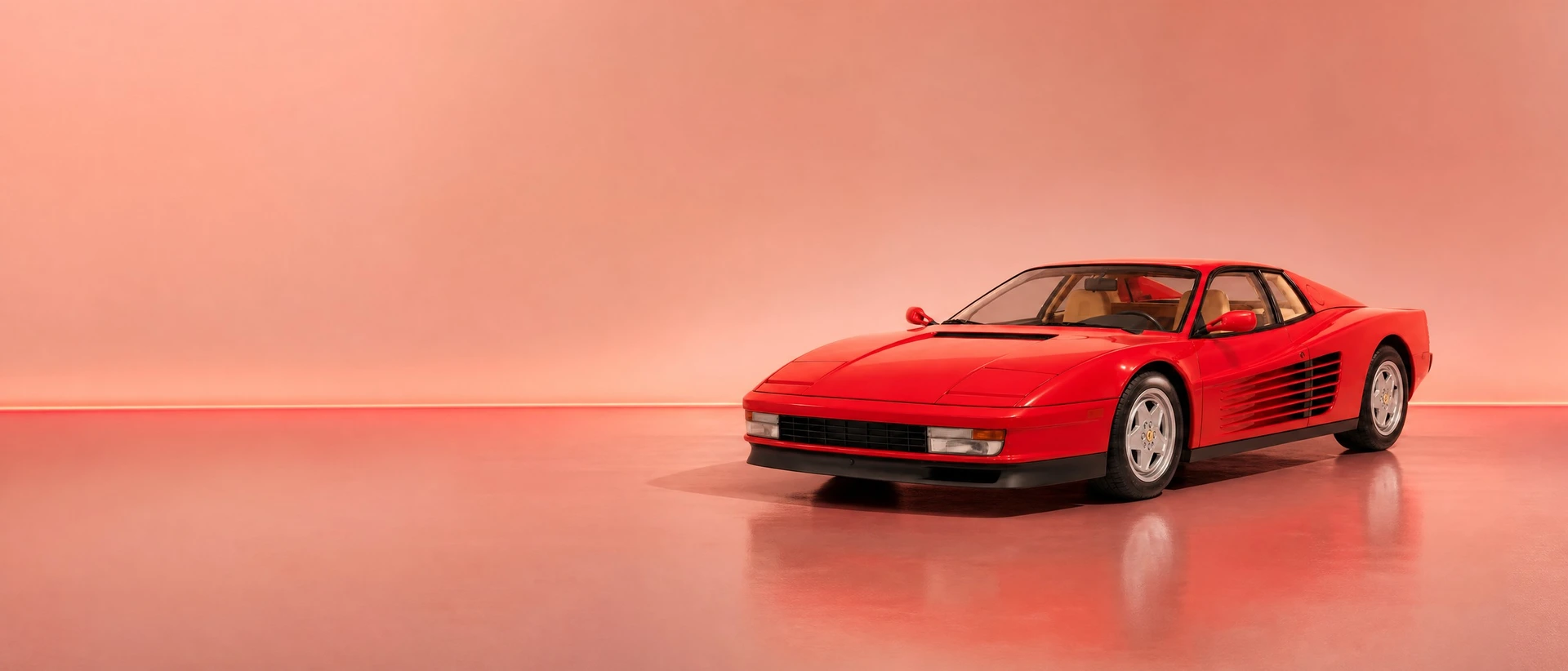 A red Ferrari Testarossa, front three-quarter view on a pastel field with a neon-red horizon