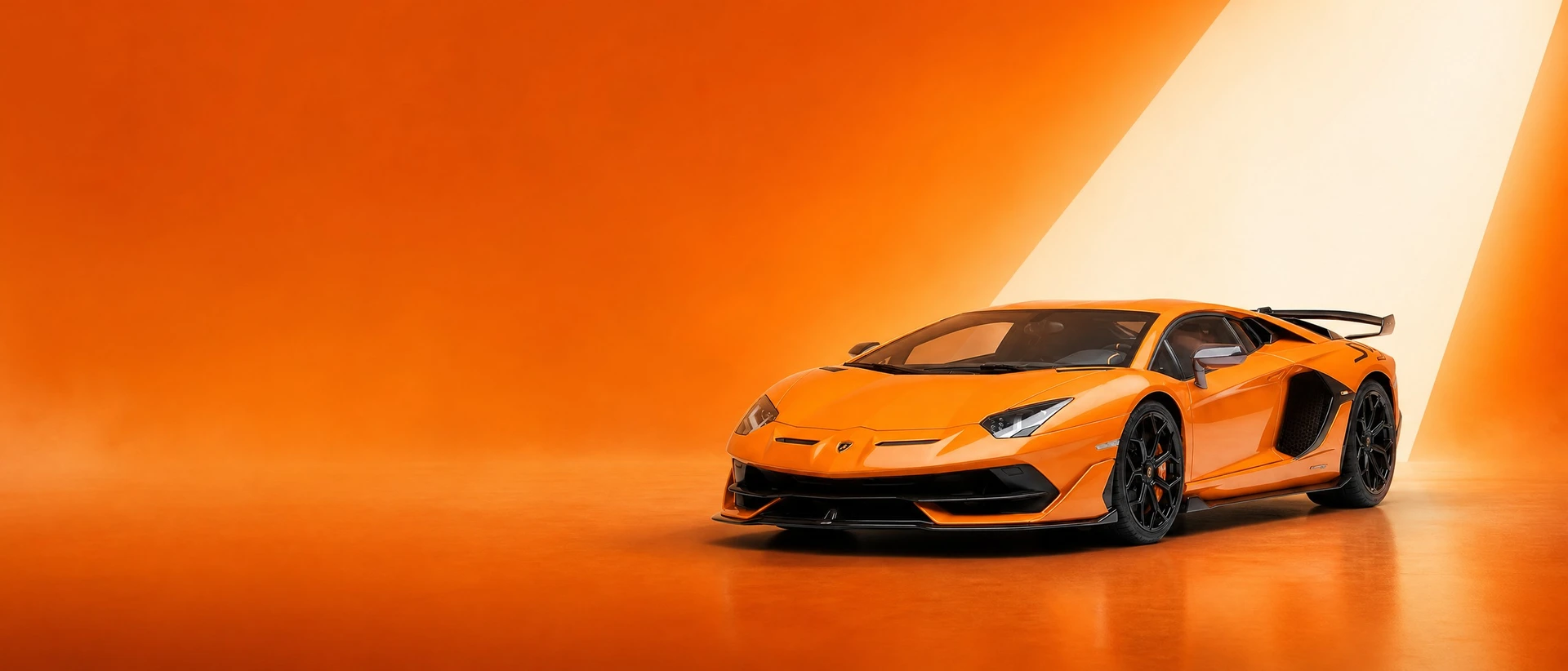 An orange Lamborghini Aventador, front three-quarter view on an arancio field with a wedge of light