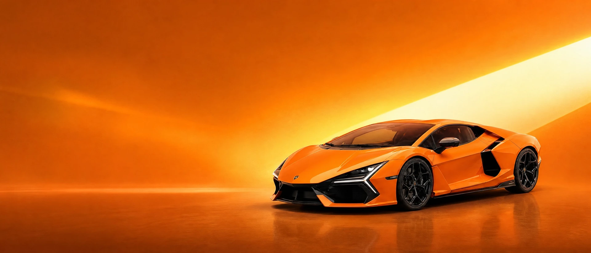 An orange Lamborghini Revuelto, front three-quarter view on an orange-to-gold field with a forward wedge