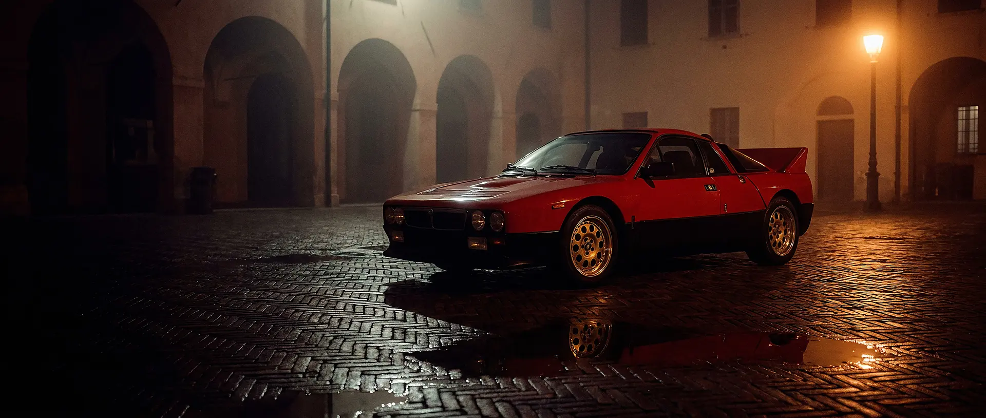 Red Lancia Rally 037 Stradale, front three-quarter in a showroom