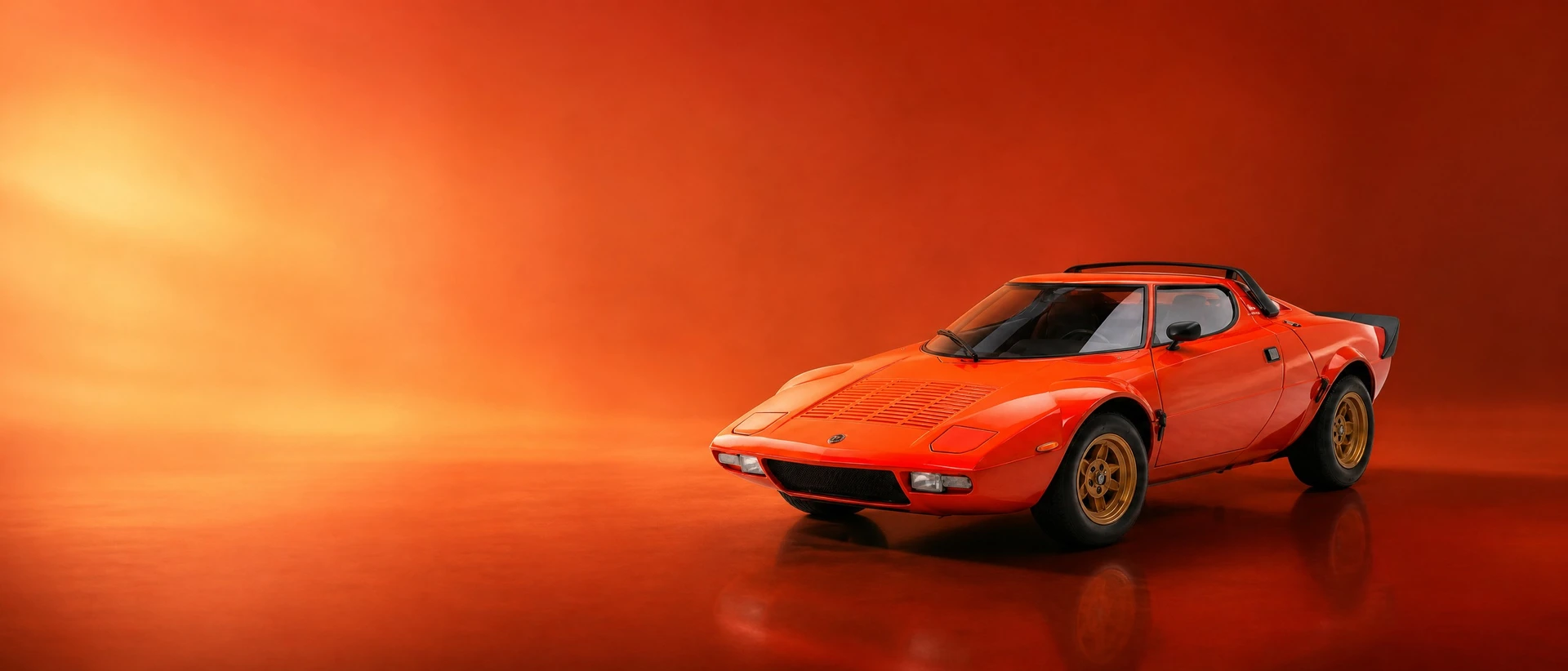 An orange Lancia Stratos HF Stradale, front three-quarter view on a warm ember field with a broad bloom of light