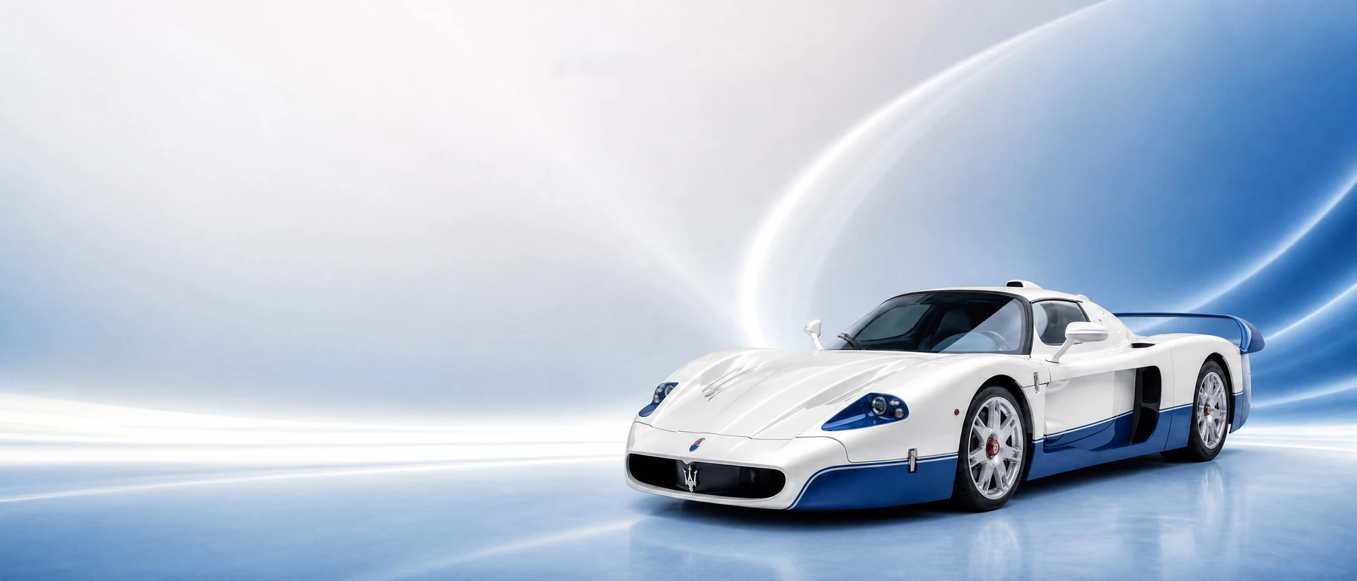 A white and blue Maserati MC12, front three-quarter view on a white-blue field with light arcs
