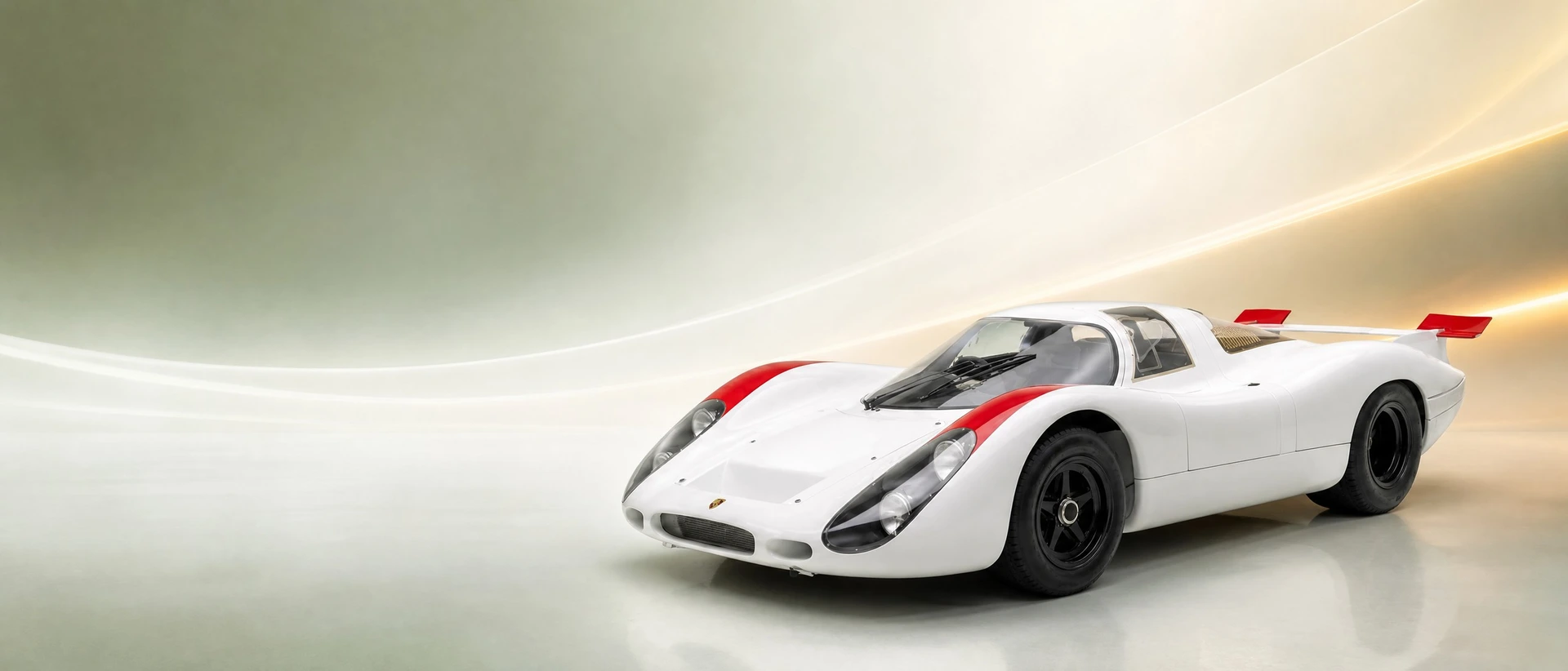 A Porsche 908 competition prototype, front three-quarter view on a green-white field with golden haze