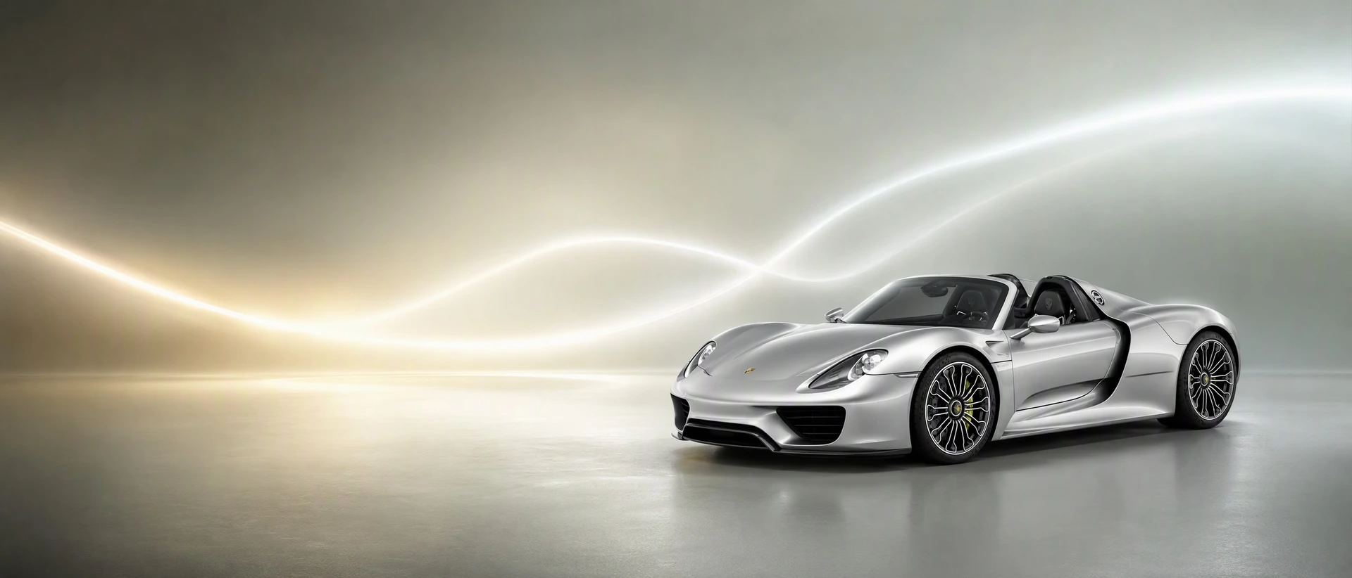 A silver Porsche 918 Spyder, front three-quarter view with two merging lines of light
