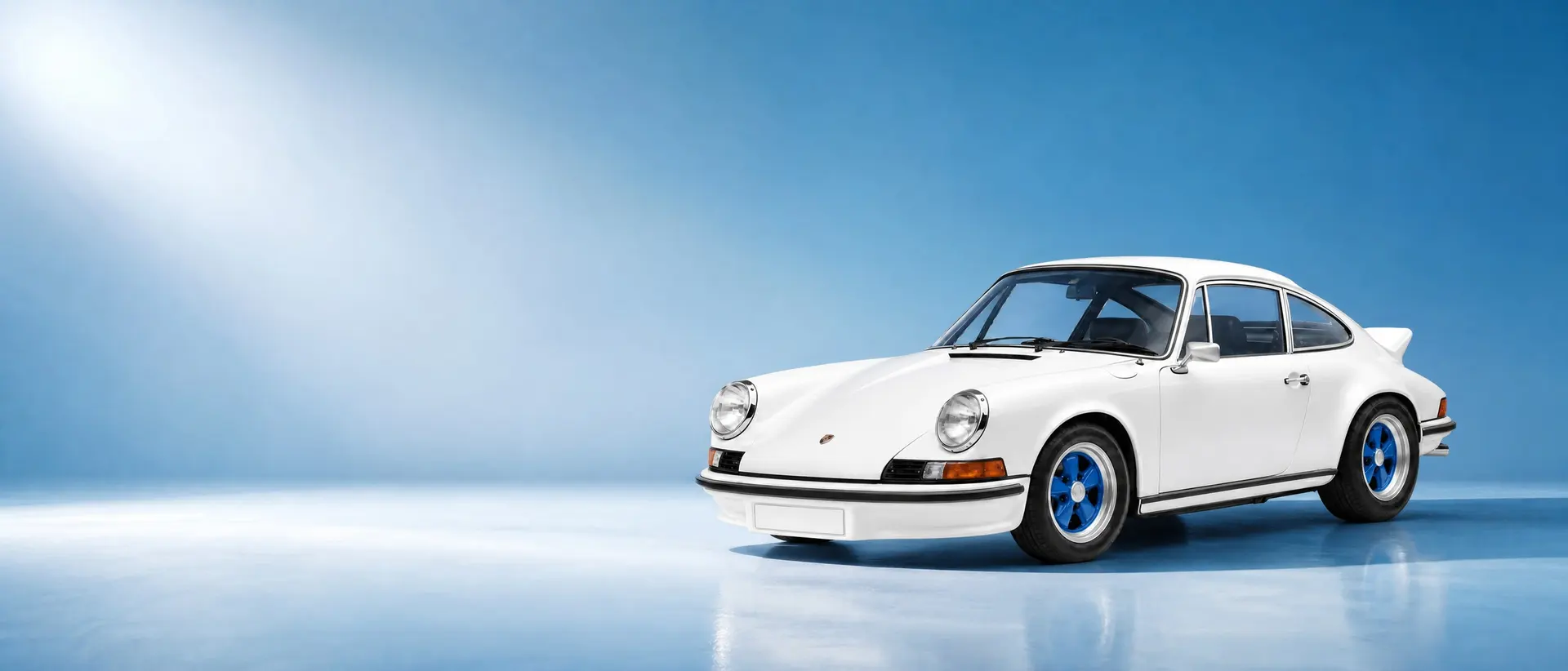 Porsche 911 Carrera RS 2.7 staged in a darkened scene