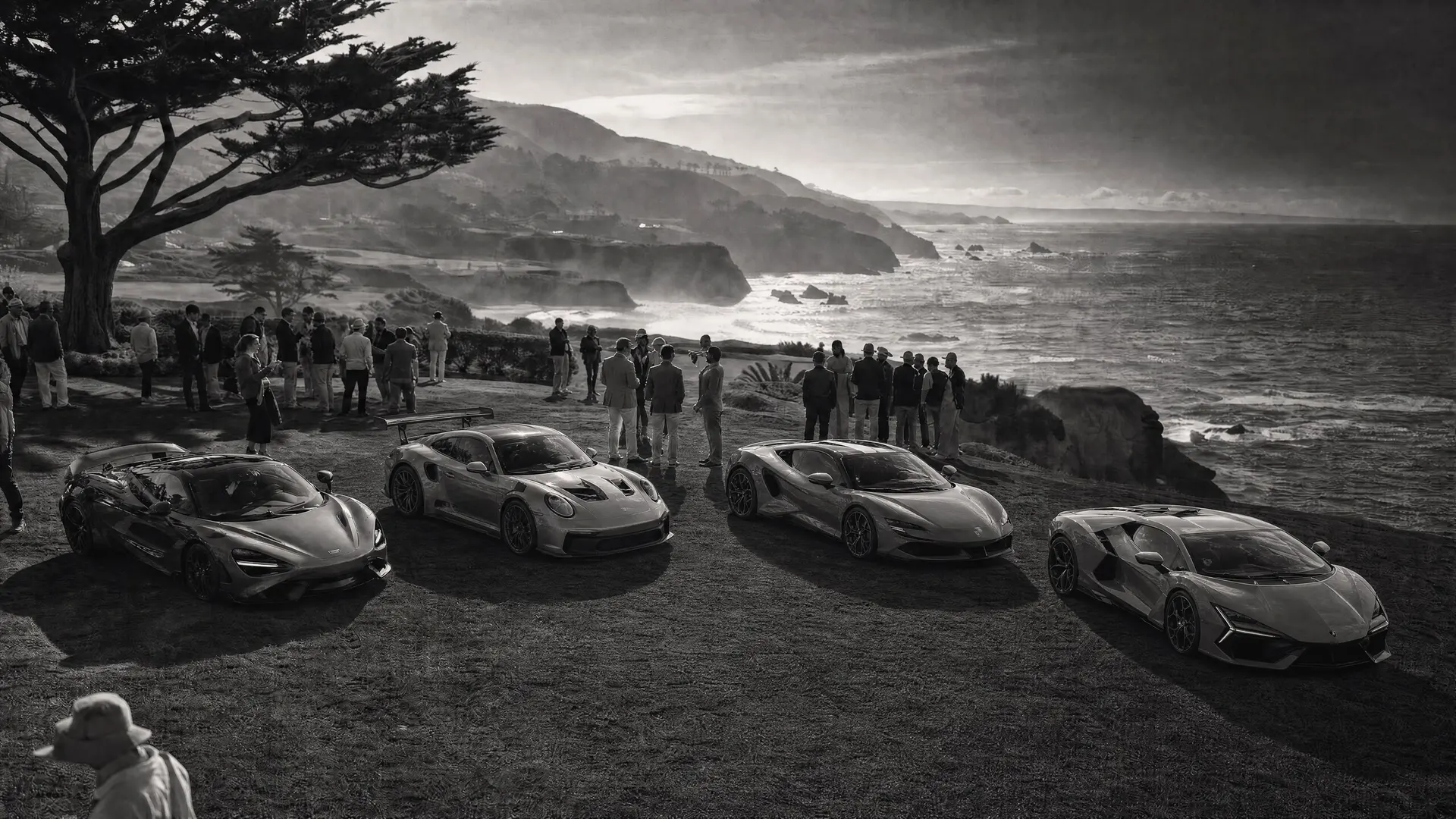 Black-and-white panorama of the Monterey coastline at dawn, cypress trees over the Pacific, a line of collector cars on Ocean Avenue, a hypercar’s arch cropped at the right edge