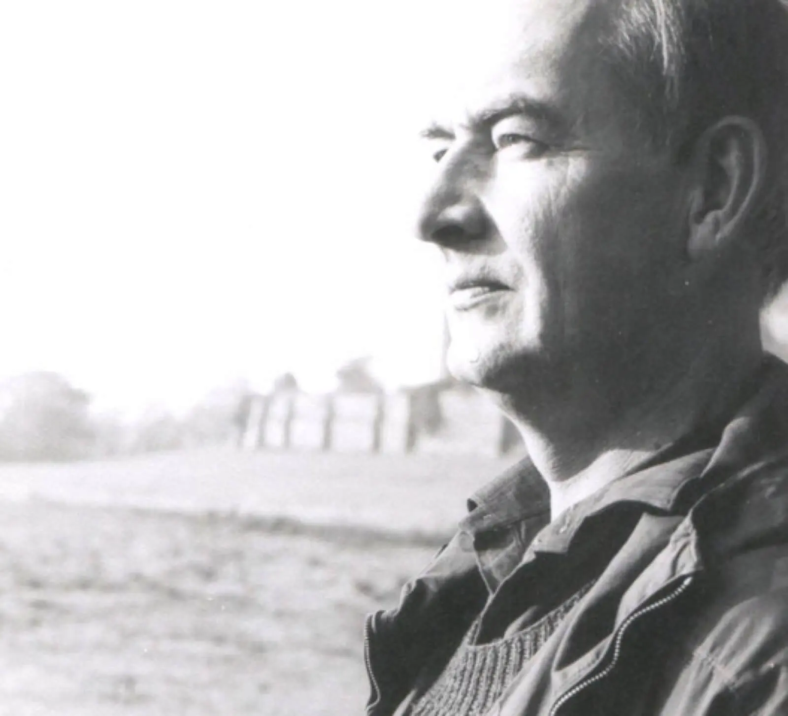 Man gazing into the distance with a thoughtful expression.
